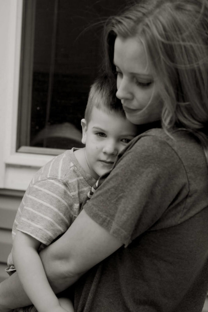 young woman cuddling with little boy