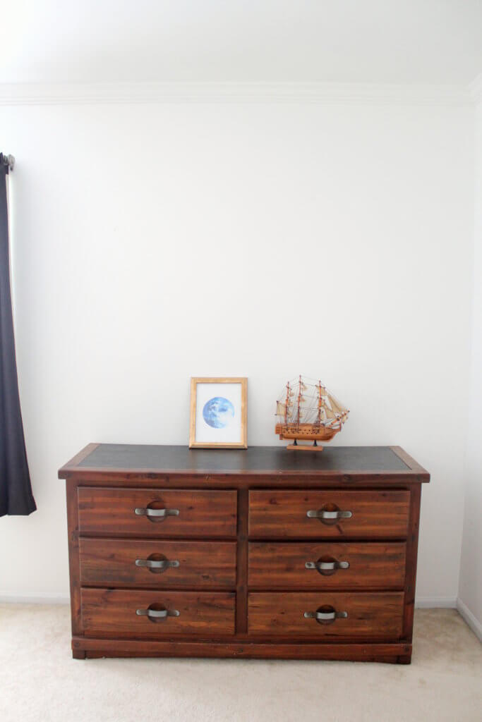 toy boat and blue moon picture on dresser