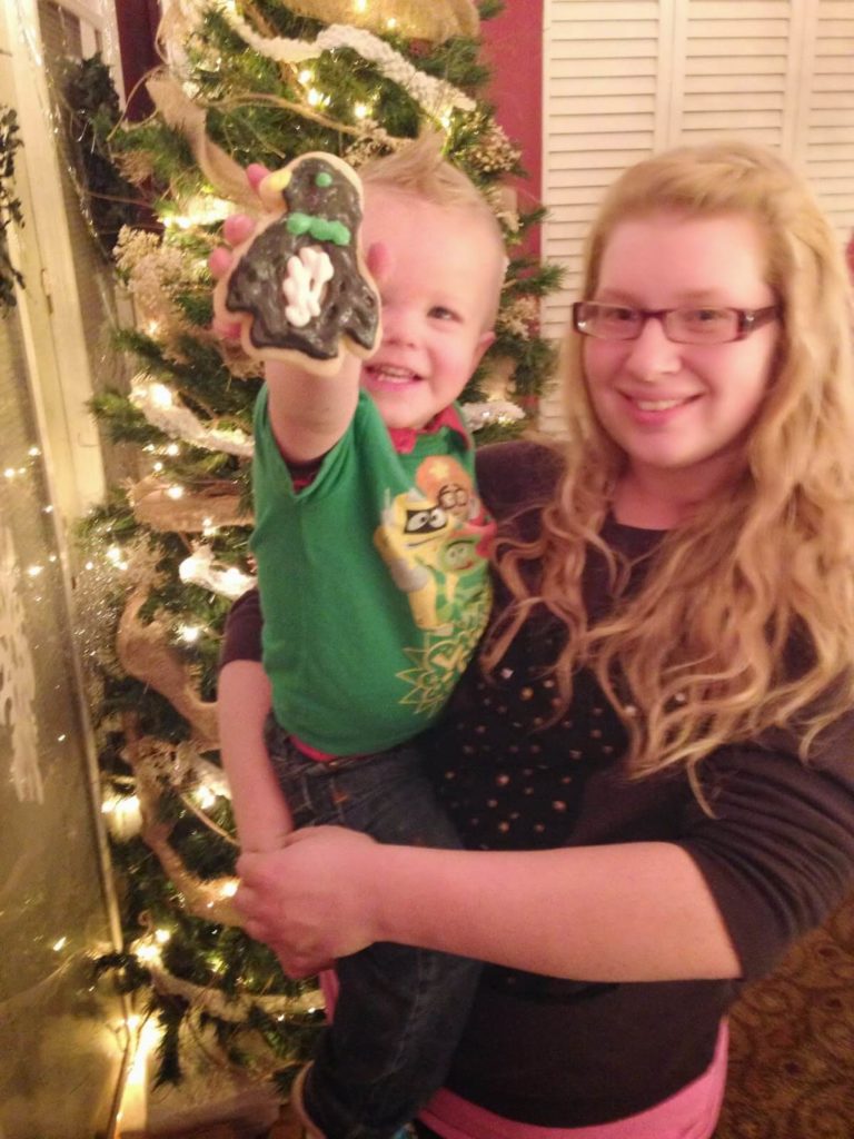 toddler boy showing cookie