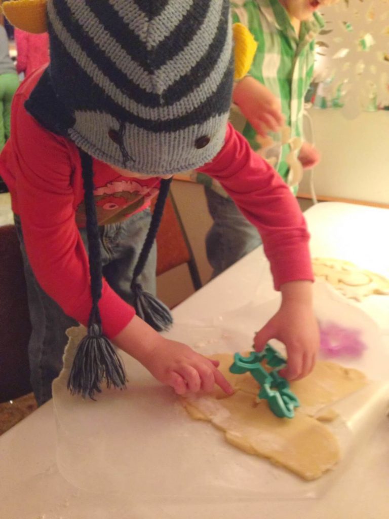 boy cutting sugar cookies