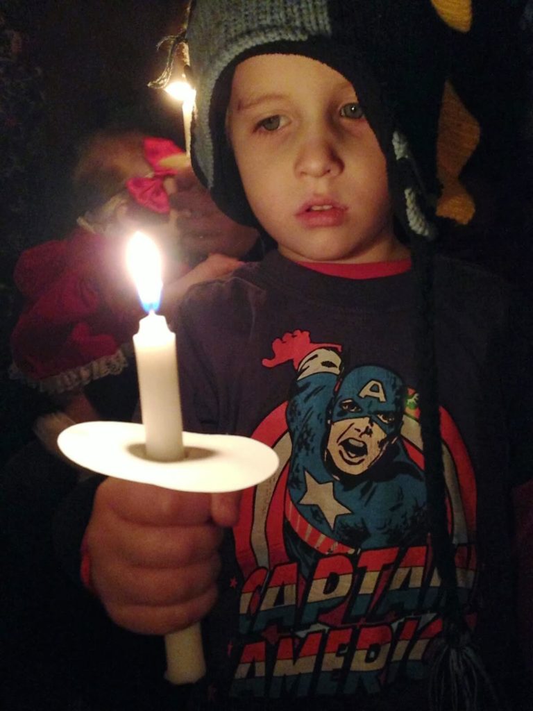boy holding candle