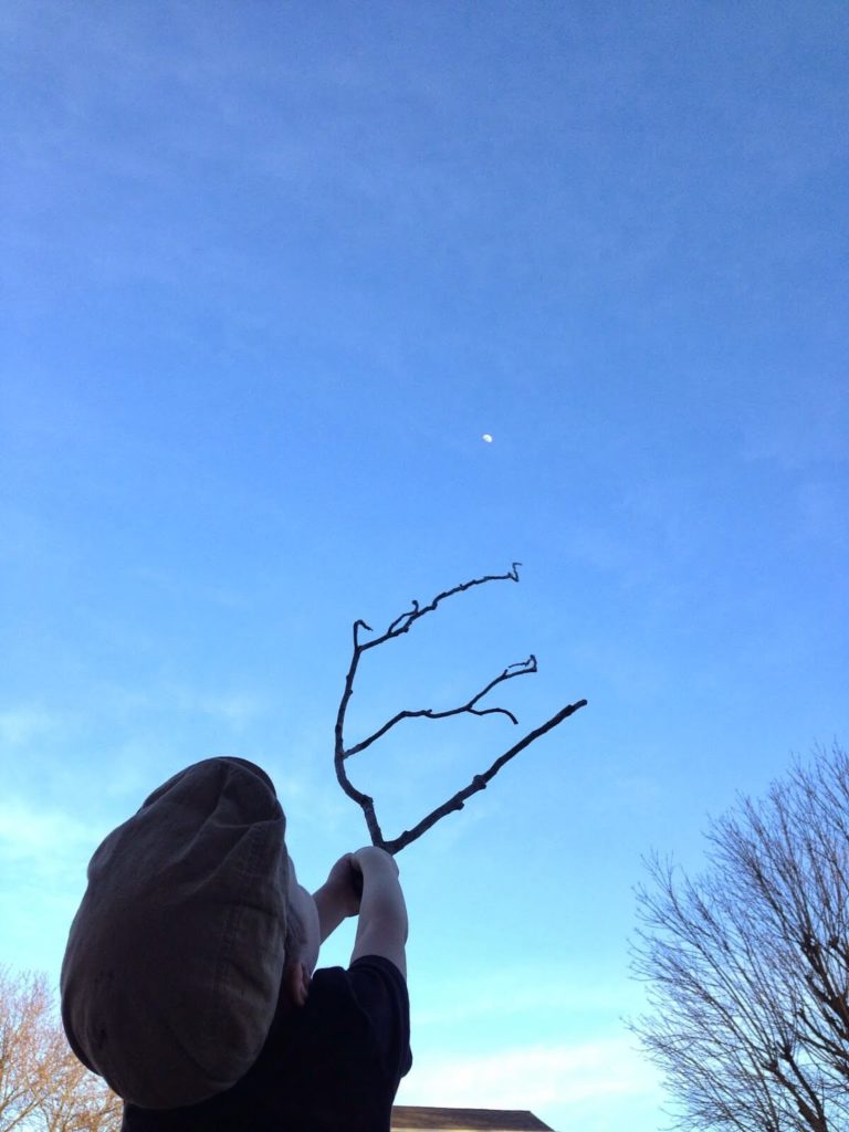 boy reaching to the moon