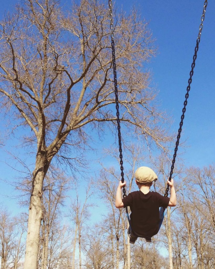 boy on swingset