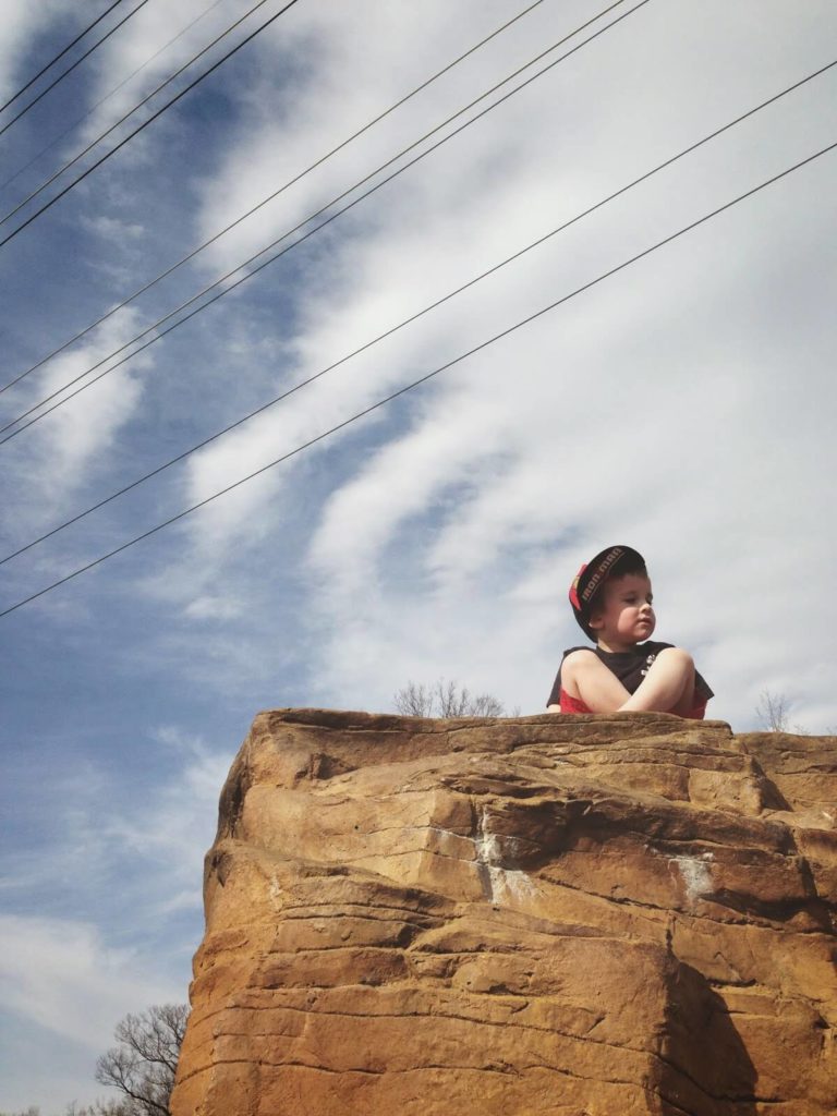 liam sitting on rock