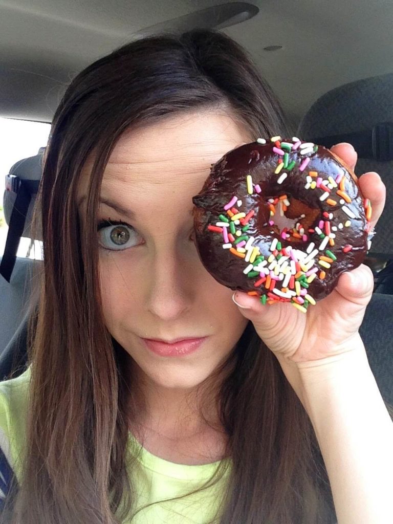 chocolate sprinkle donut over womans eye