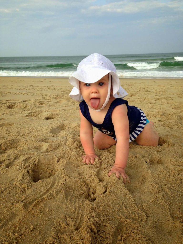 cute baby girl playing in sand