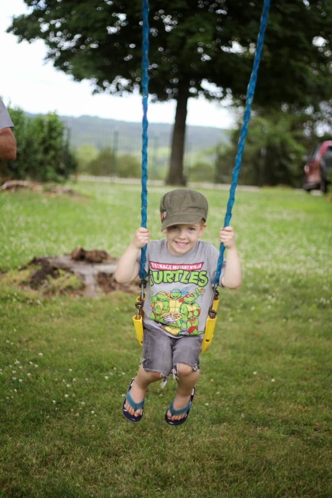 young boy swinging