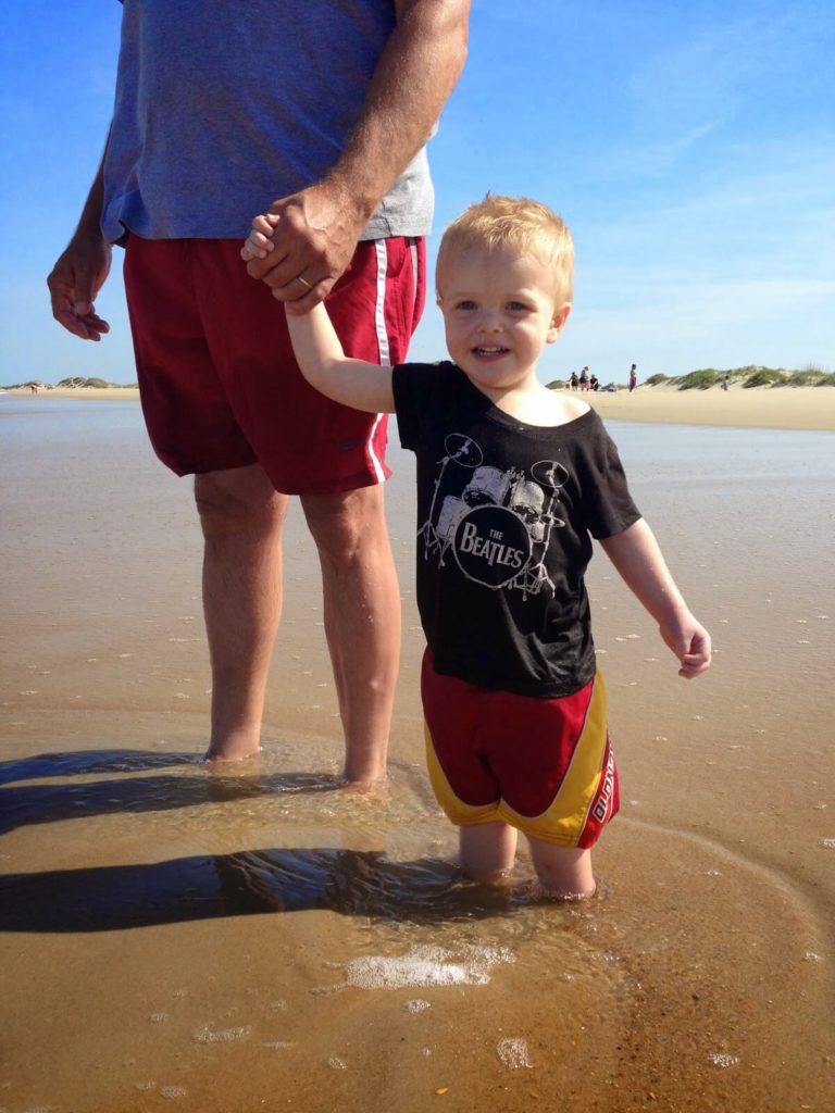 grandpa and toddler boy holding hands