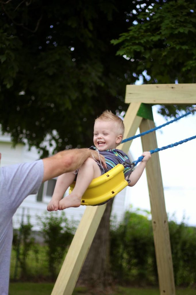 toddler boy swinging