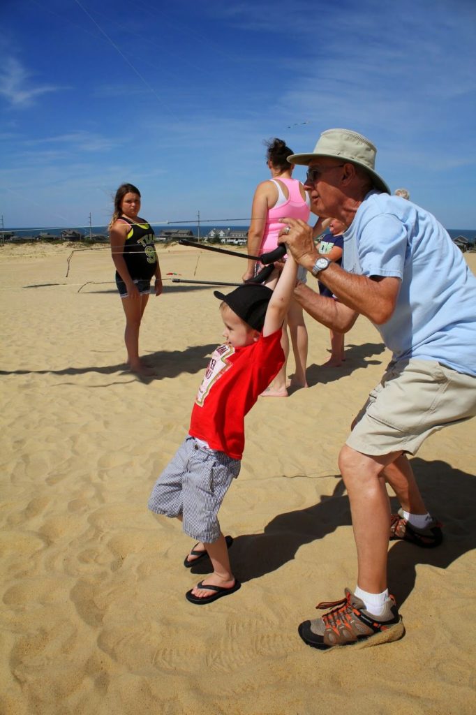 boy learning how to fly kite