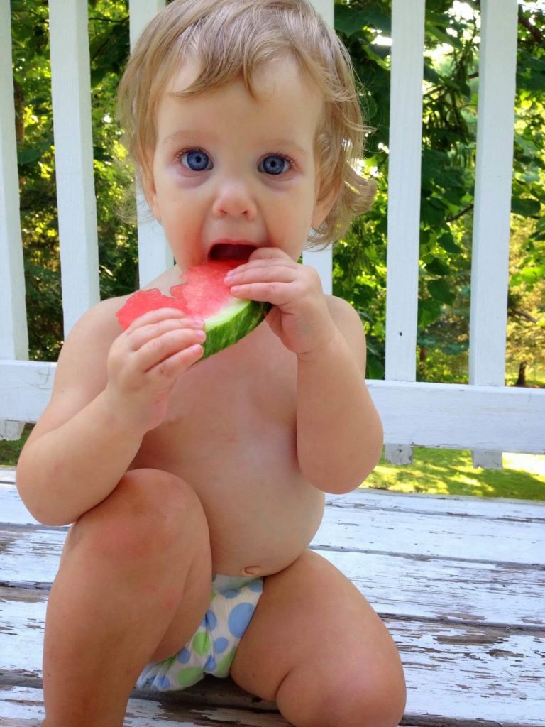 cute baby girl eating watermelon