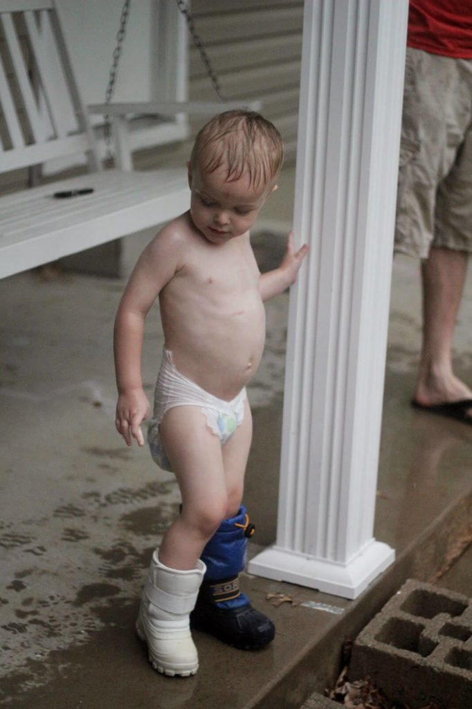 toddler boy in rain