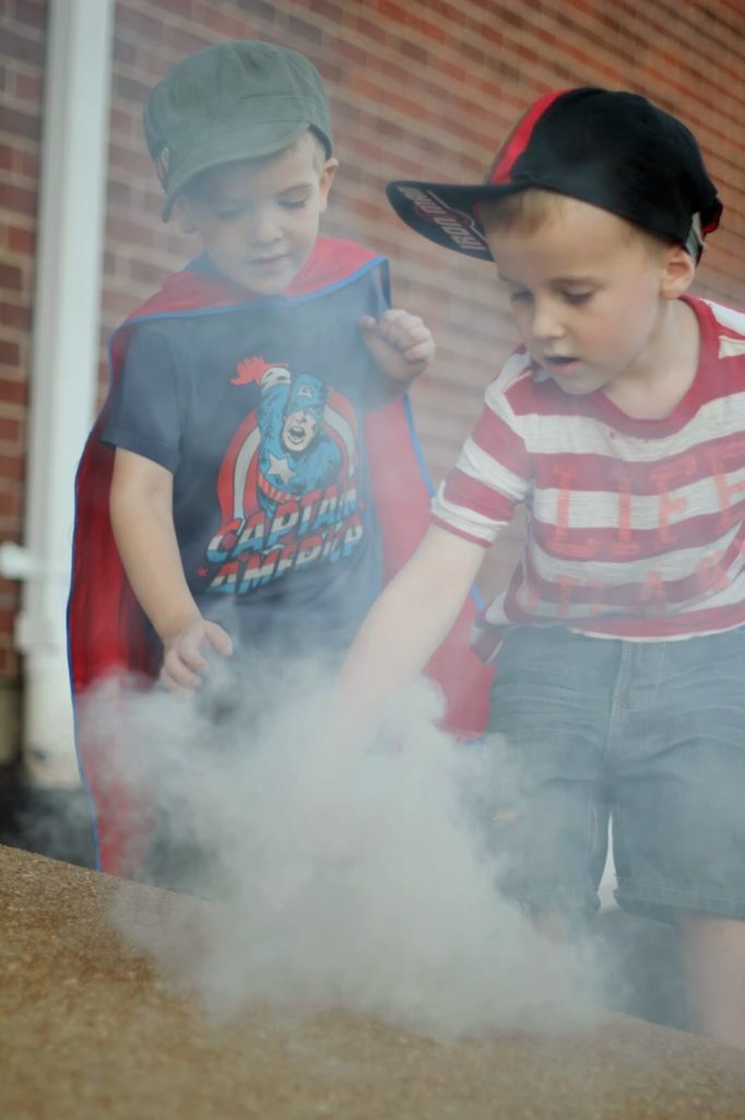 2 boys playing in smoke bombs