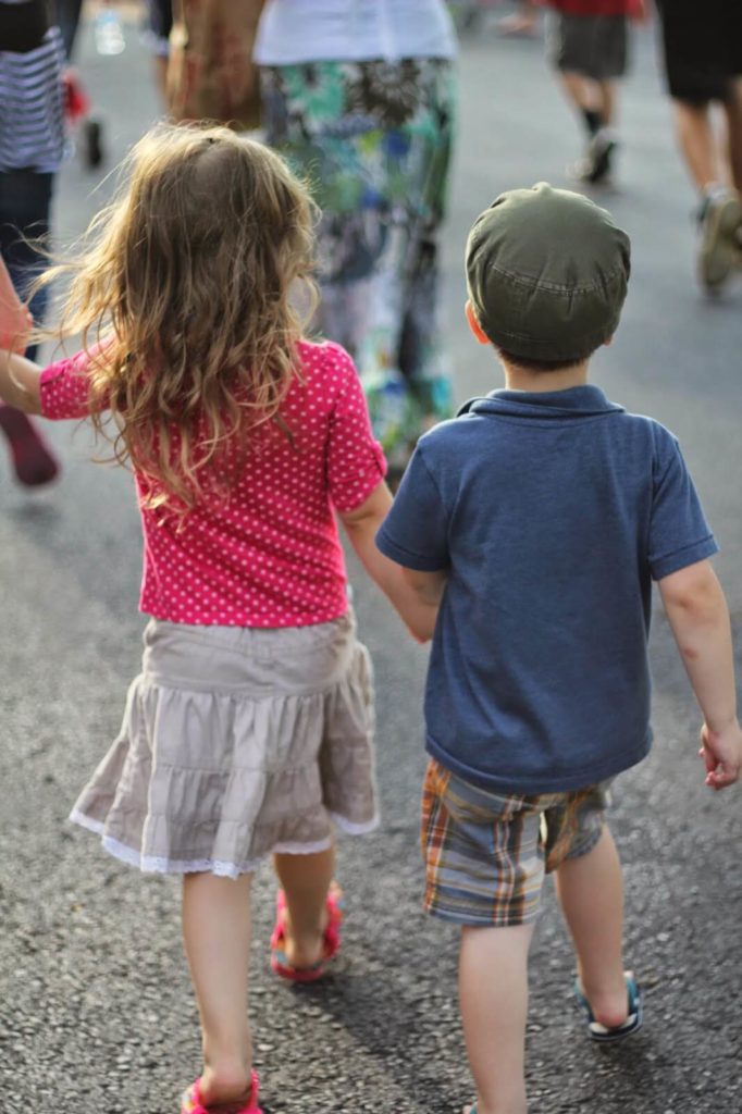 little boy and girl holding hands