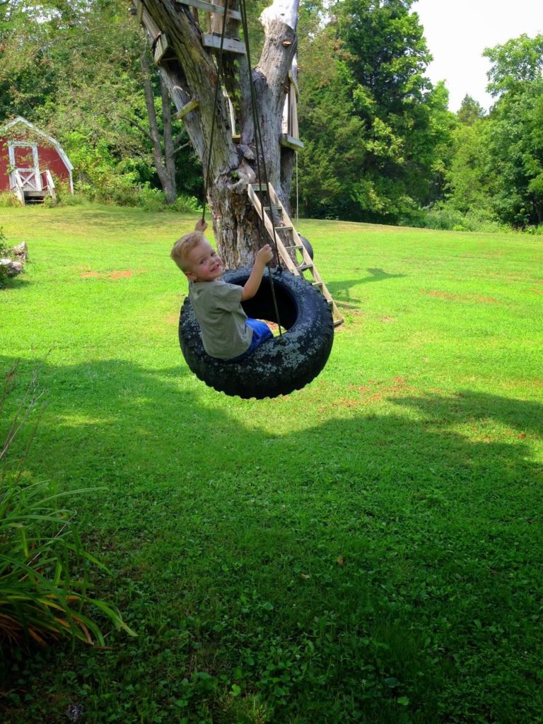 toddler swinging on tire swing