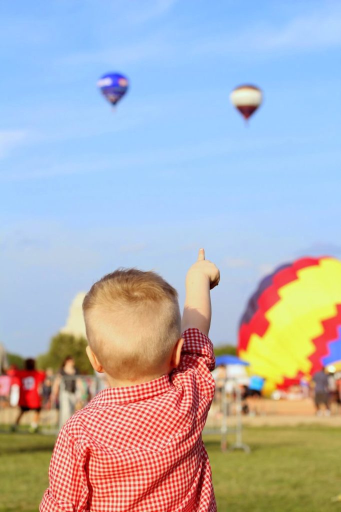 toddler boy pointing at hot air balloon