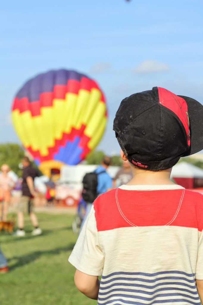 boy looking at hot air balloon