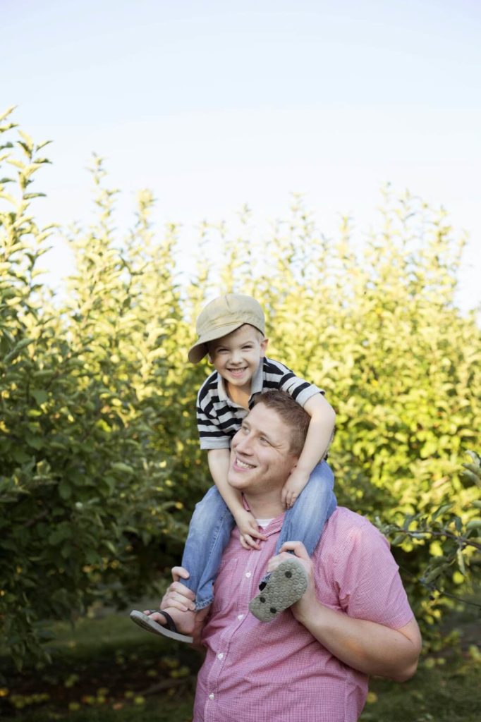 man giving boy piggy back ride