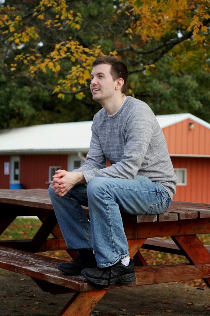 man sitting on picnic table