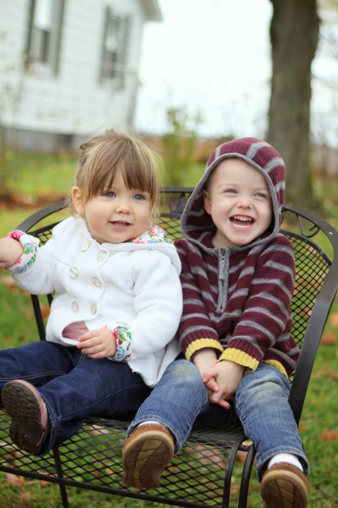 boy and girl sitting on chair