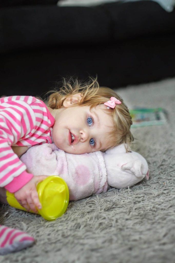 little girl laying on blankie