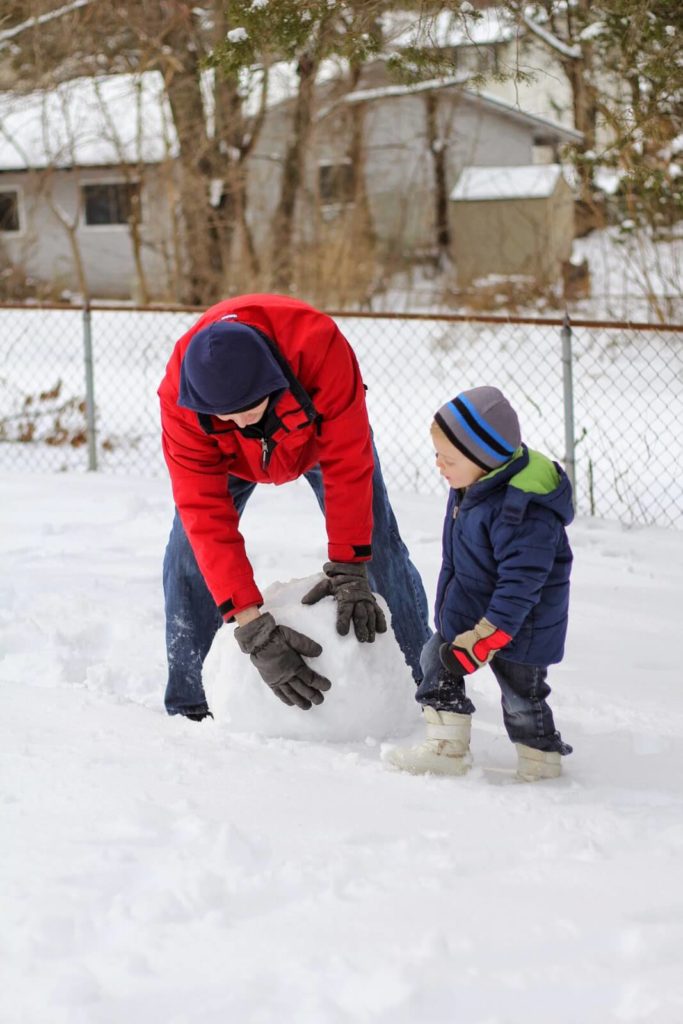 dad and son making snowman