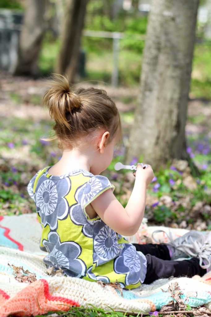 girl blowing bubbles