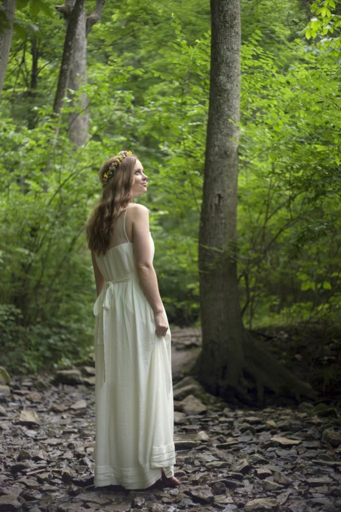 girl standing in forest