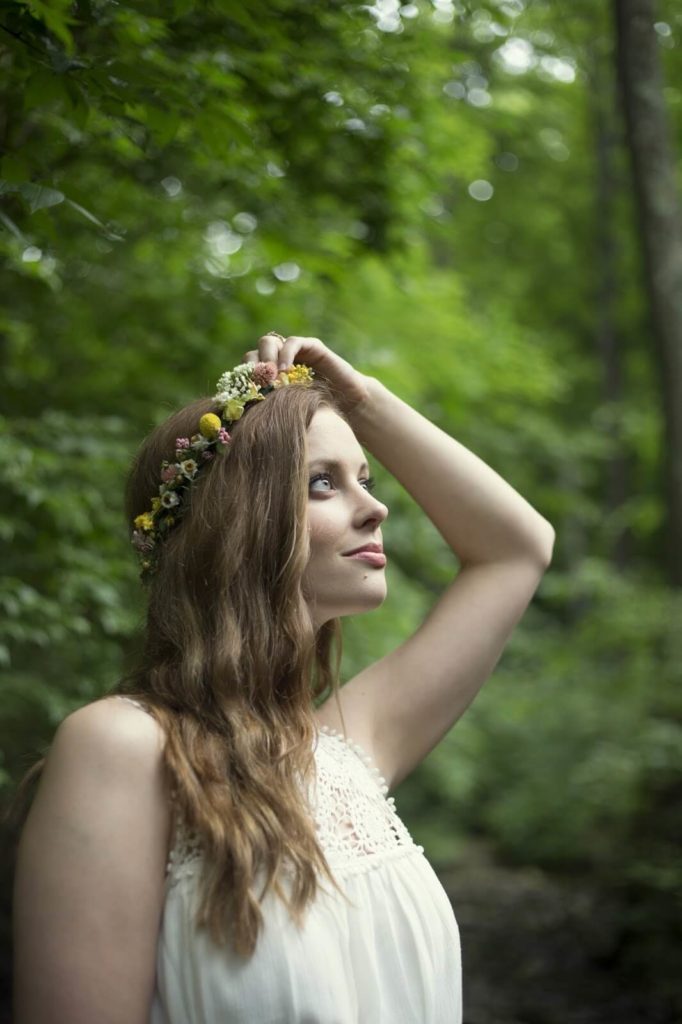 girl looking up at trees