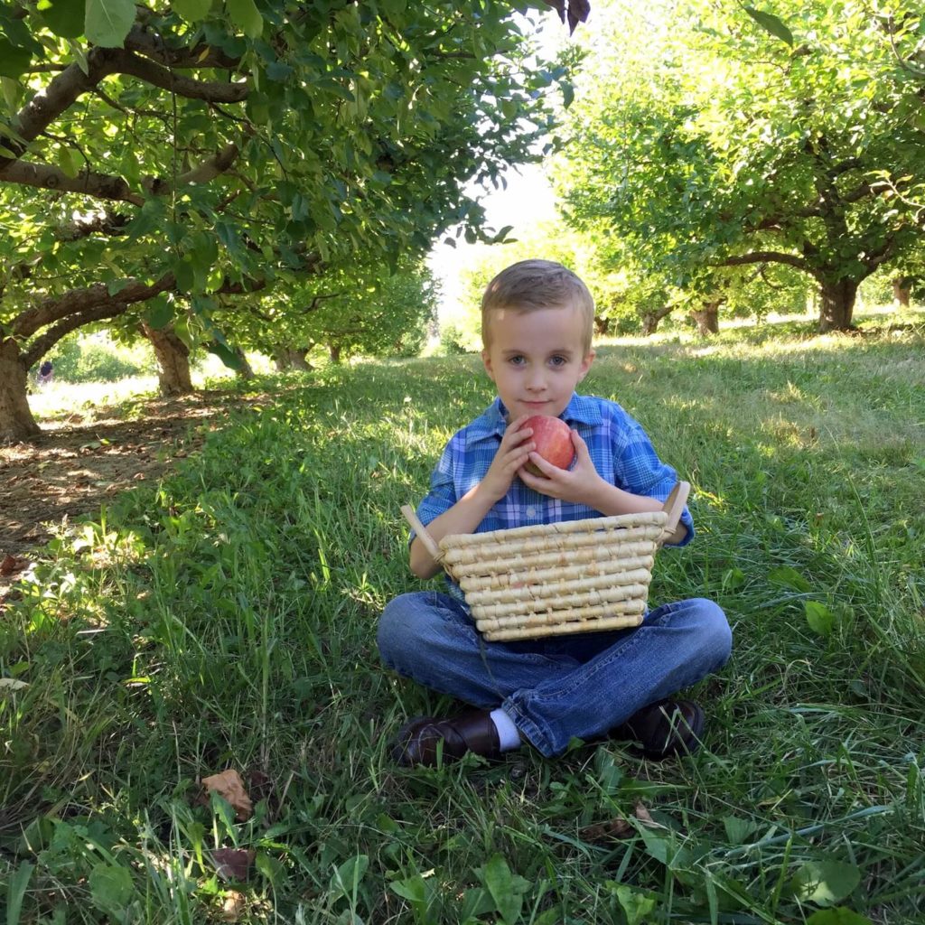 liam holding an apple