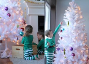 children decorating our white christmas tree