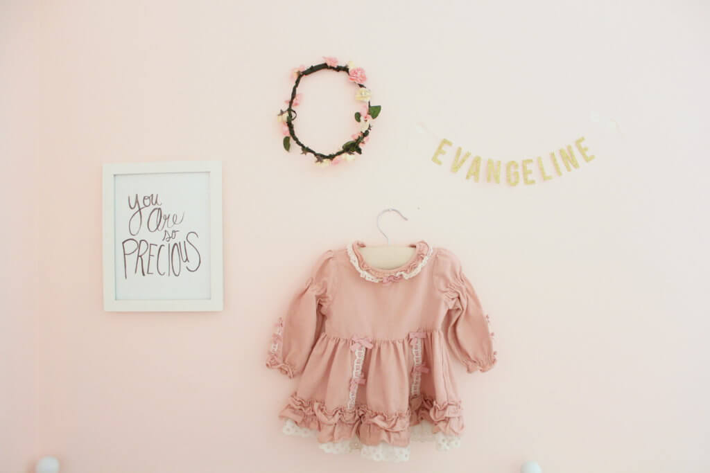 name banner flower crown vintage dress and picture hanging on the wall