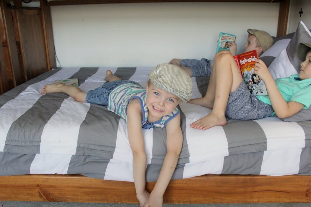 boys reading books in bed